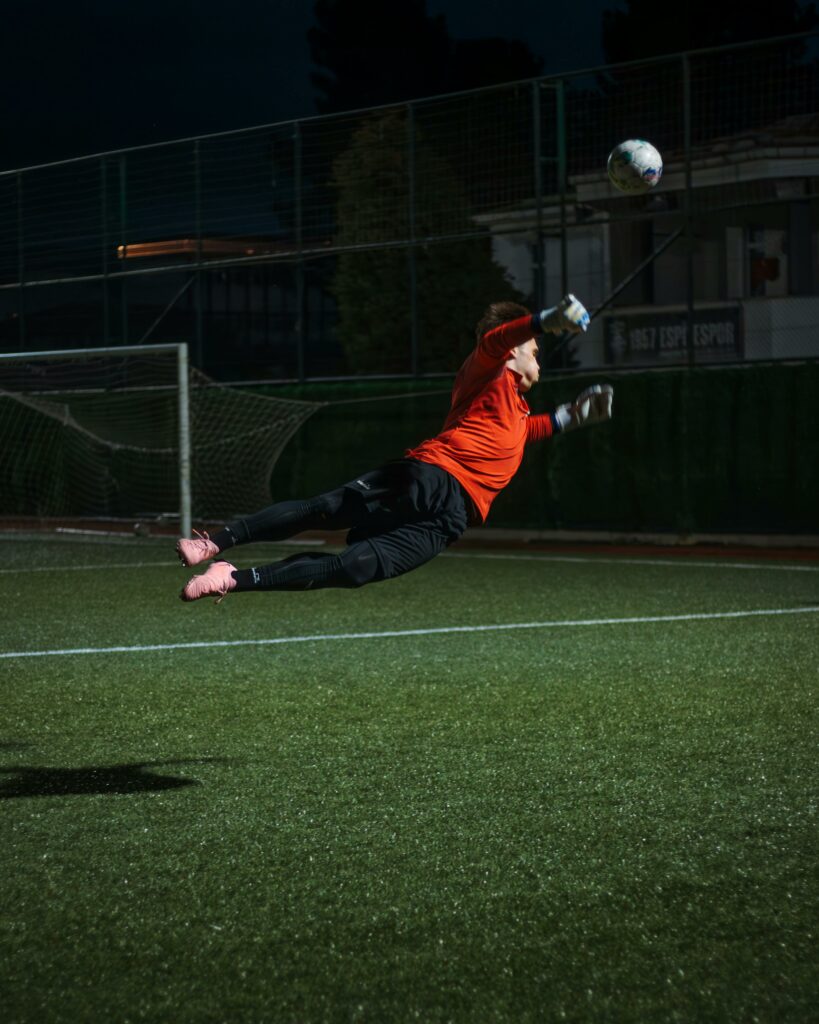 pexels photo 29073416 29073416 Goalkeeper diving for a save during a night training session on a soccer field.
